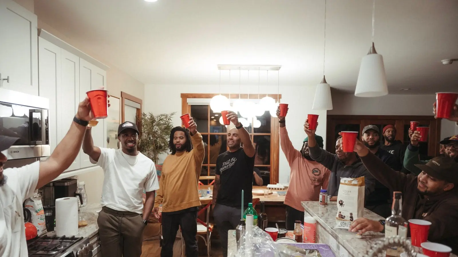 The men raising cups together in celebration