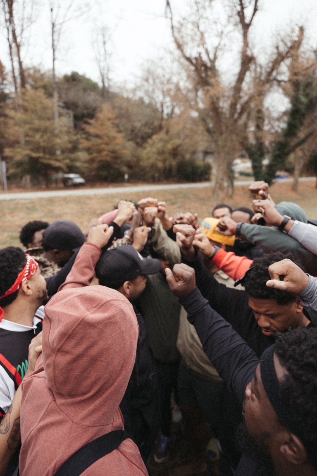Men gathering with their fists raised together